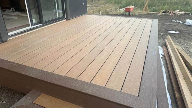 Composite deck with dark border material by Whyte Ave Landscaping Edmonton
